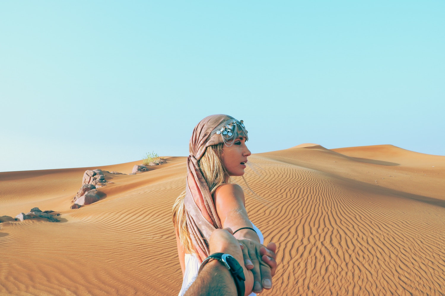 Couple holding hands in the desert